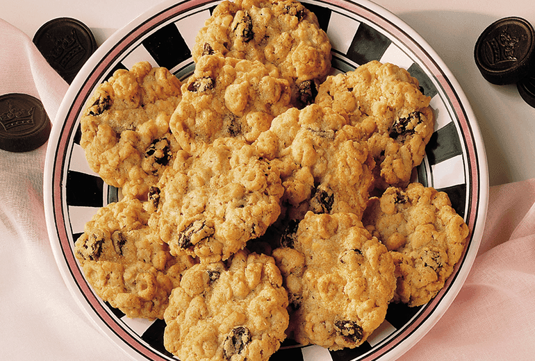 Overhead view of Cheerios added to oatmeal & raisin cookies, served on a plate.