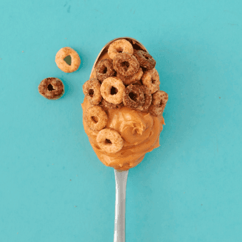 Instagram post featuring peanut butter and Cheerios on a spoon. - Link to social post